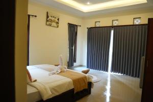 Postel nebo postele na pokoji v ubytování Alit Bungalow Ubud