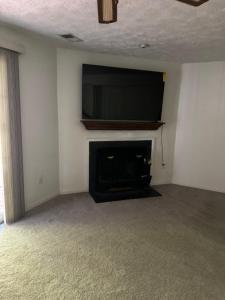 a living room with a flat screen tv and a fireplace at Cozy 3-bedroom townhome in Fairfax in Fairfax