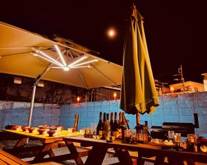 a table with an umbrella and bottles of wine at Moon River Court - Vacation STAY 19871v in Fujiyoshida