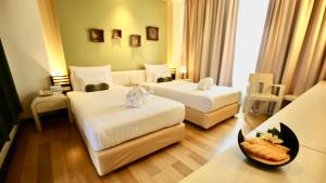 Ein Bett oder Betten in einem Zimmer der Unterkunft A-Te Chumphon Hotel - SHA Plus