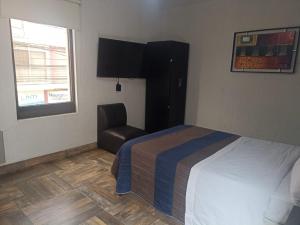 Postel nebo postele na pokoji v ubytování Hotel Dalia