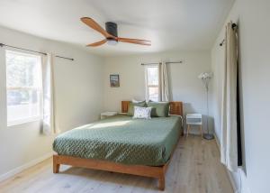 a bedroom with a bed with a ceiling fan at Cozy Crater Lake House Close to Hwy97 in Klamath Falls