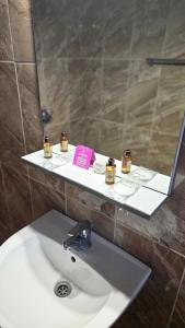 a bathroom with a sink and a mirror and a sink at Vila Dana in Costinesti +20 photos