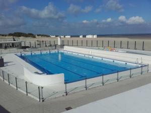 a large swimming pool on top of a building at Villa Parrain in Koksijde