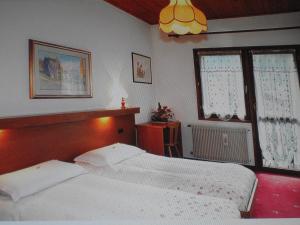 Posteľ alebo postele v izbe v ubytovaní Garni Meublè La Baita