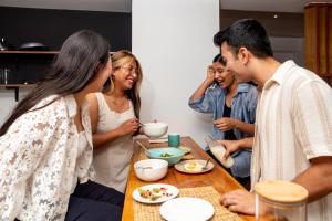 a group of people sitting around a table eating food at Nomad Hotel in Kathmandu