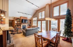 a kitchen and living room with a table and a couch at Select Unit 1710 - 2BR - Zephyr Mountain Lodge condo in Winter Park
