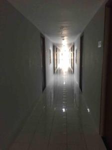 an empty hallway with a light at the end of a building at 2BR Podomoro Golf View Cimanggis with Netflix near exit Toll Jagorawi in Tjikuda Tiga