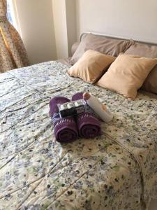 a pair of purple socks on a bed at 2BR Podomoro Golf View Cimanggis with Netflix near exit Toll Jagorawi in Tjikuda Tiga