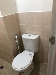 a bathroom with a white toilet in a room at 2BR Podomoro Golf View Cimanggis with Netflix near exit Toll Jagorawi in Tjikuda Tiga