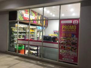 a store front with glass windows in a grocery store at 2BR Podomoro Golf View Cimanggis with Netflix near exit Toll Jagorawi in Tjikuda Tiga