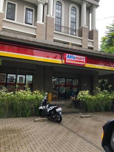 a motorcycle parked in front of a building at 2BR Podomoro Golf View Cimanggis with Netflix near exit Toll Jagorawi in Tjikuda Tiga