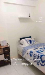 a small bedroom with a bed and a nightstand at 2BR Podomoro Golf View Cimanggis with Netflix near exit Toll Jagorawi in Tjikuda Tiga
