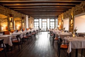 a dining room with white tables and chairs at Hotel Schloss Waldeck in Waldeck