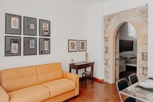 a living room with a couch and a table at New Design Ortigia in Siracusa