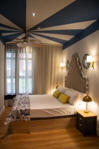 a bedroom with a large bed with a blue ceiling at Maison Primado B&B in Valencia +40 photos