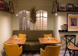 a restaurant with two tables and yellow chairs at Maison Primado B&B in Valencia