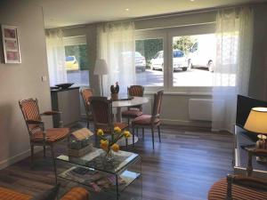 a living room with a table and chairs at Chouet mon appart in Eu