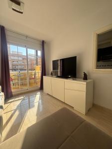 a living room with a television and a large window at Brisa y Mar Aguadulce II in Aguadulce