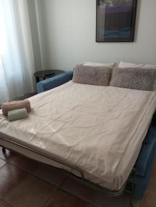 a hospital bed with white sheets on top of it at Villa Primerose Guest House in Saint-Raphaël