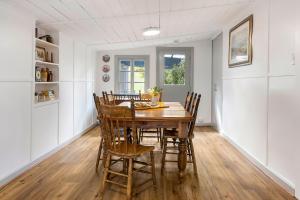 a dining room with a wooden table and chairs at Heysen Hideaway in Summertown