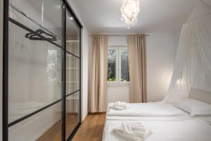 a bedroom with two beds and a chandelier at Black & White - heated pool in Pula