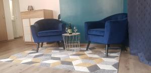 two blue chairs and a table with a bottle of wine at Bauer Brumm in Nordheim