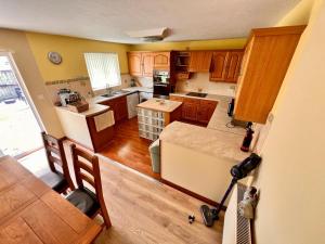 an overhead view of a kitchen with wooden cabinets at Devon Bungalow in Holsworthy