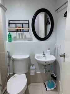 a bathroom with a white toilet and a sink at Coco's Tagaytay in Tagaytay +5 photos