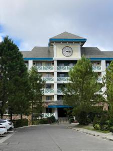 a large building with a clock tower on top of it at Coco's Tagaytay in Tagaytay
