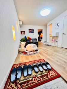 a living room with a group of shoes on the floor at 星の宿 in Osaka