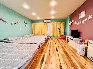 a bedroom with a large bed and a television at 星の宿 in Osaka
