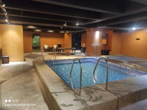 a large swimming pool in a hotel room at Jjimjbang hotel spa in Manila