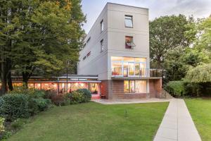 a large white building with a lawn in front of it at Safestay London Kensington Holland Park in London