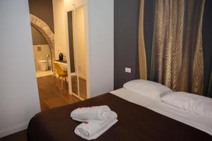 Postel nebo postele na pokoji v ubytování Vicolo delle Belle Suite