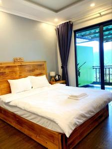 a bedroom with a large bed and a large window at Daun Pisang Homestay & Halal Food in Sapa +44 photos