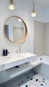 a bathroom with a white sink and a mirror at Sweett - Hotel Particulier Garden in Cannes