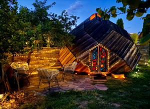 a igloo house with chairs and lights in a yard at La bulle de sérénité in Six-Fours-les-Plages