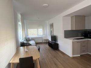 a kitchen and a living room with a table and a dining room at Mar de Queiruga: 02 Xeiteira in Porto do Son