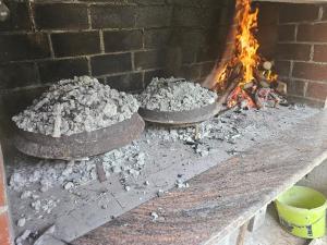 a fire in a brick oven with two large tires at Guest house SARA in Čapljina +24 photos