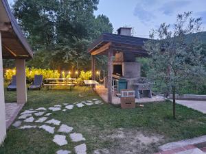 a backyard with a grill and a patio with a table at Guest house SARA in Čapljina