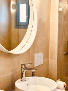 a bathroom with a sink and a mirror at κατοικιά PAROS in Drios +21 photos