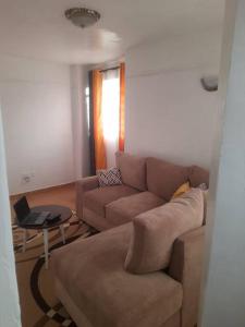 a living room with a couch and a table at Nyona Homes in Kalimoni