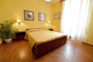 a bedroom with a bed and a plant in it at Hotel Rosalia in Bordighera