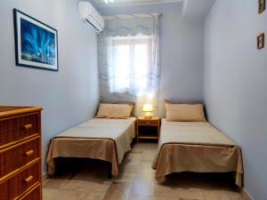 A bed or beds in a room at Jana Holidays