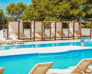 a group of lounge chairs and a swimming pool at Dream Escape Mobile Home in Vodice