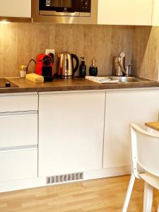 a kitchen with white cabinets and a sink at Casa Maria City in Solothurn +11 photos