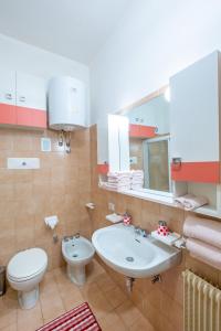a bathroom with a sink and a toilet at Happy Guest Apartments - Pink Mountain Presolana in Castione della Presolana