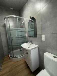 a bathroom with a glass shower and a sink at Рада Дараба in Krasnik +66 photos