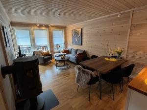 a living room with a table and a couch at Leilighet på Tyinkrysset in Tyinkrysset
